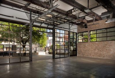 interior view of the 800 congress event space facing the patio and outside area during the day